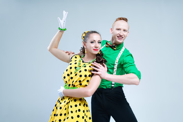 Portrait lovely funny dancer couple dressed in pin up style