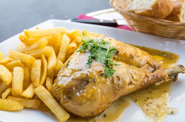 Chicken with sauce and golden French fries