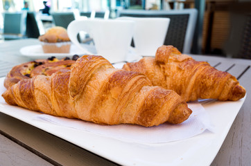 Breakfast with coffee and croissants