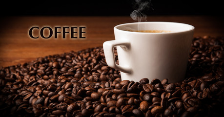 cup of black coffee with roasted coffe beans