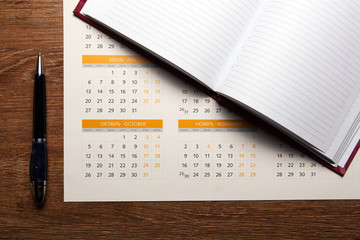 wall calendar with pen and diary closeup