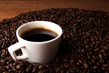 cup of black coffee with roasted coffe beans