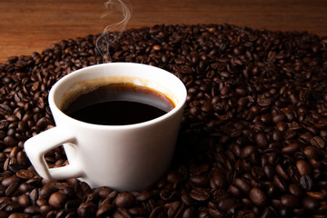 cup of black coffee with roasted coffe beans
