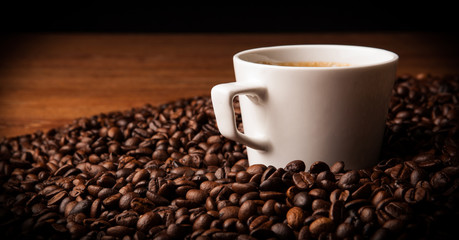 cup of black coffee with roasted coffe beans