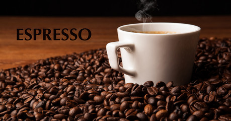 cup of black coffee with roasted coffe beans