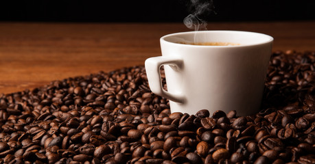 cup of black coffee with roasted coffe beans