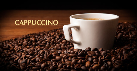 cup of black coffee with roasted coffe beans