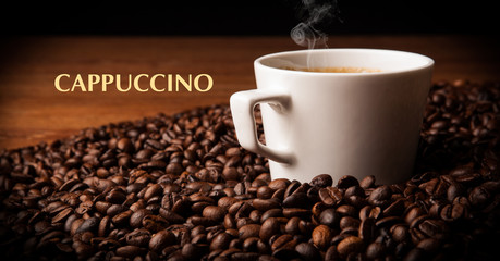 cup of black coffee with roasted coffe beans