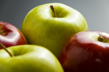 Four apples on black background.