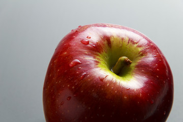 Red fresh apple on silver background