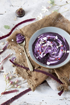 purple carrot cream soup with sour milk cream on bowl