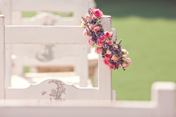 Wedding ceremony chairs and a wreath of roses