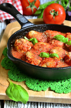 Meatballs with rice in a pan.
