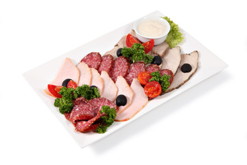 Cold cuts on plate, isolated over white background.