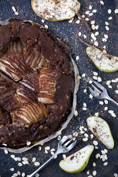 homemade pears and dark chocolate tart  with oat flakes
