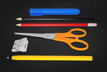 Set of school or office desk items on blackboard