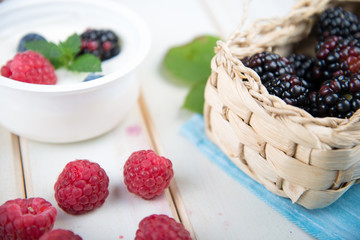 fresh berrys fruit in basket on wooden table