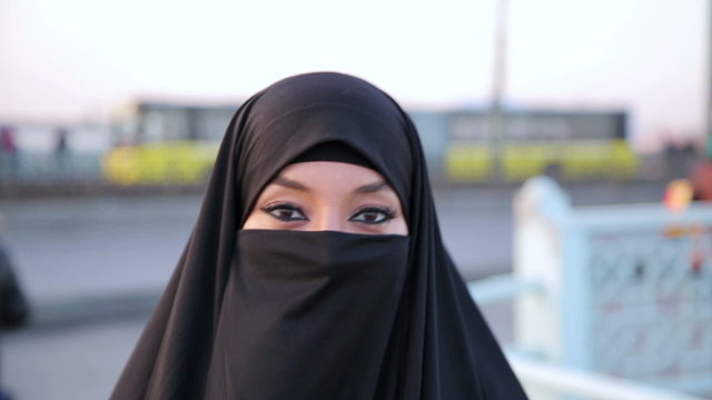 Steadycam, Woman dressed with black headscarf, chador walking, istanbul