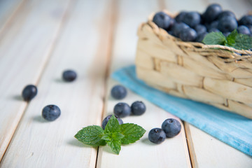Fresh blueberries in basket on kitchen table