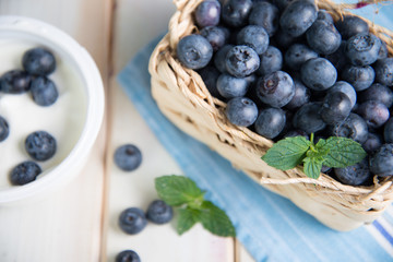 Fresh blueberries in basket on kitchen table