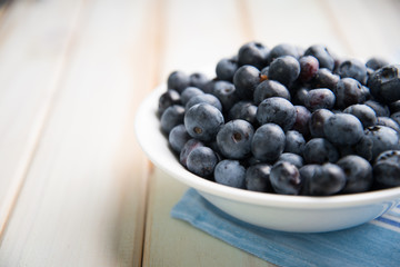 fresh blueberries ion white plate on kitchen table