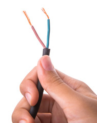 Female hand holding exposed electrical wire over white 