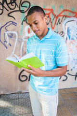 Young sexy male reading a book.