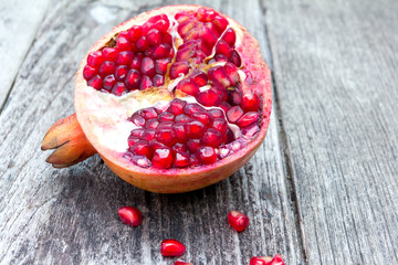 Juicy pomegranates on wood