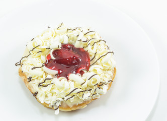 Donut with jam on white dish