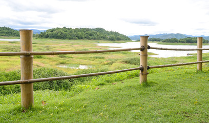 Fototapeta na wymiar bamboo fence at the edge of the lake