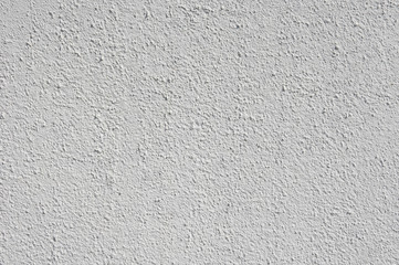 Light gray rough plaster on wall closeup