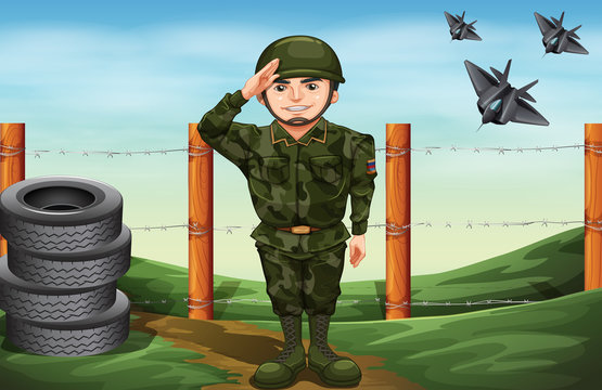 A soldier in front of the barbwire fence