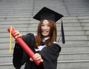 Beautiful female graduate wearing a graduation gown