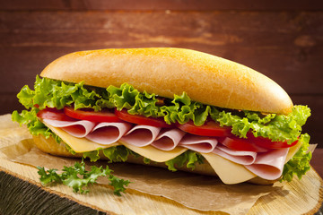 big sandwich with ham, cheese and vegetables