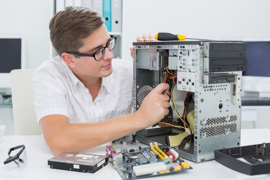 Young Technician Working On Broken Computer