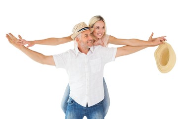 Happy man giving his partner a piggy back