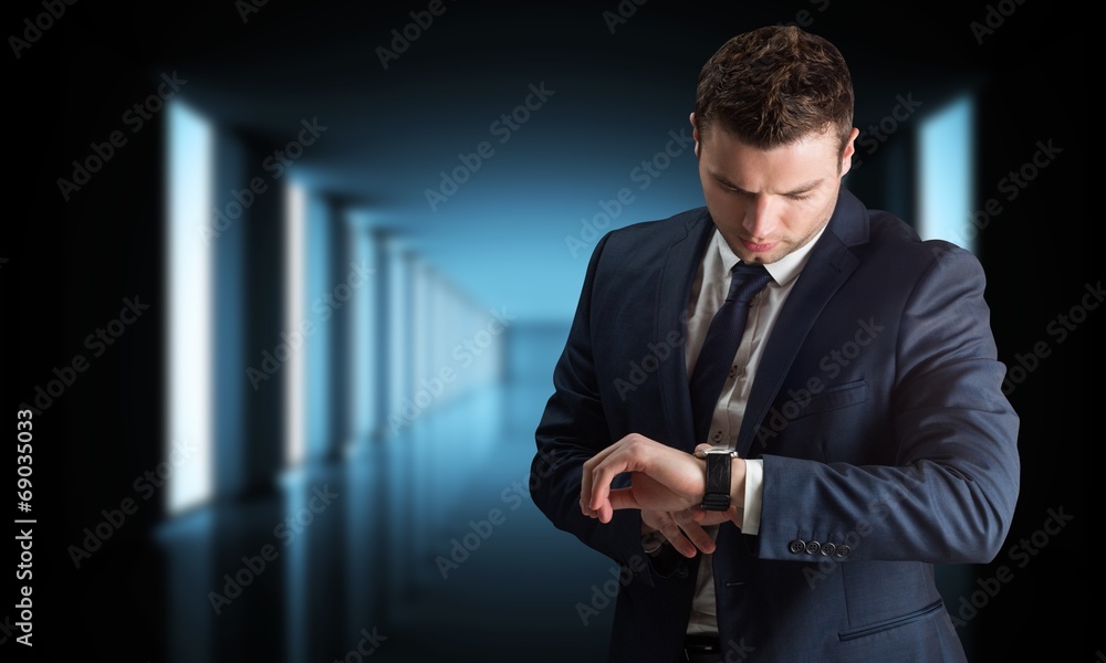Poster composite image of handsome businessman checking the time