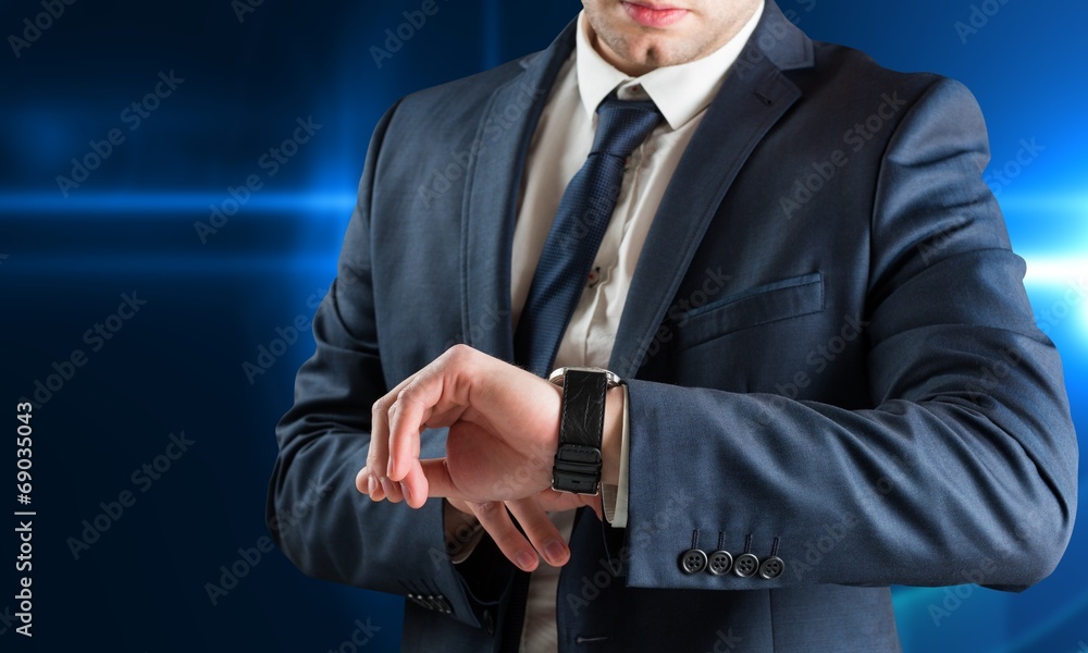 Poster composite image of businessman checking the time on watch