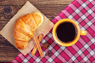 Coffee cup with a croissant