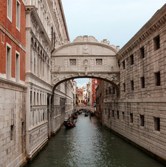 famous bridge of sighs in Venice with gondolas