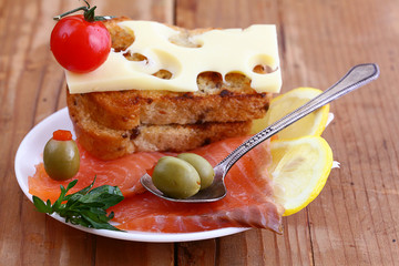 toast salmon and herbs on a wooden background
