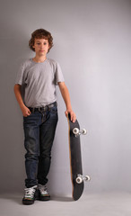 happy boy sitting on skateboard