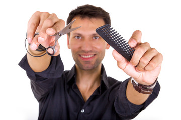 professional hairdresser holding scissors and comb