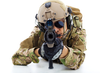 Soldier with rifle and lying on floor over white background