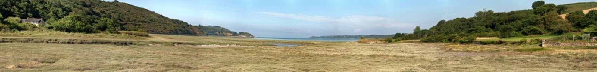 Coastal panoramic grass landscape with blue sky. Brittany. Franc