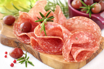 Salami with fresh rosemary sprigs and olives