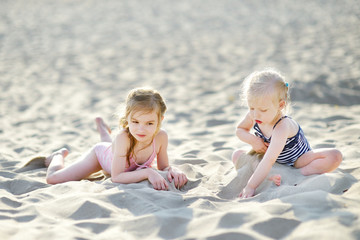 Two little sisters having fun on a beach © MNStudio