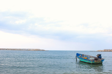 Naklejka na ściany i meble Small fishing wooden boat in the sea