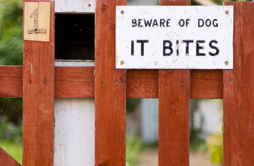 dog bites sign on a garden gate.