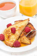 French toast with fresh raspberries and maple syrup
